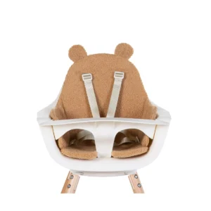 White baby high chair with beige bear-shaped cushion and safety straps.