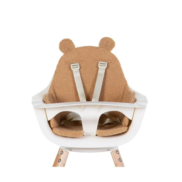 White baby high chair with beige bear-shaped cushion and safety straps.